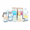 Flor de Coco CLEAN LIVING kit with natural cleaning products for laundry, dishes, bathrooms, and floors. Includes bottles, jars, and a brush.
